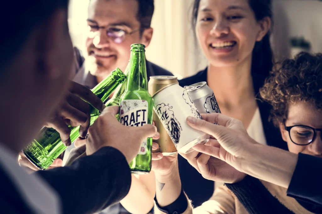 Zoomed image of friends making cheers with their bottled and canned beers